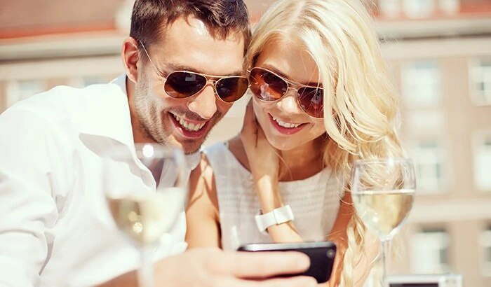 couple in sunglasses with wine