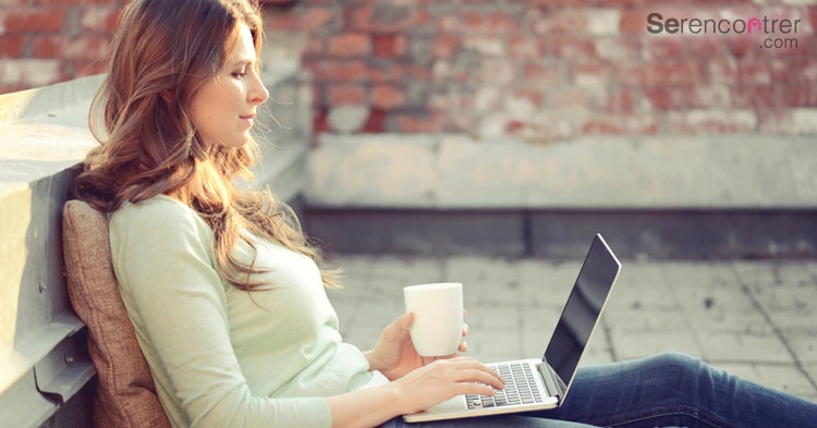 woman with laptop drinks coffee