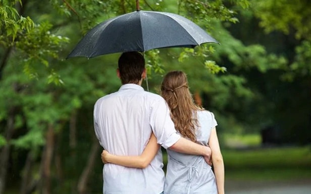 couple are hiding under umbrella